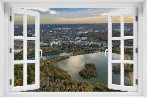 Fototapeta Naklejka Na Ścianę Okno 3D - Aerial view of a lake in a park with autumn trees. Kishinev, Moldova. Epic aerial flight over water. Colorful autumn trees in the daytime.