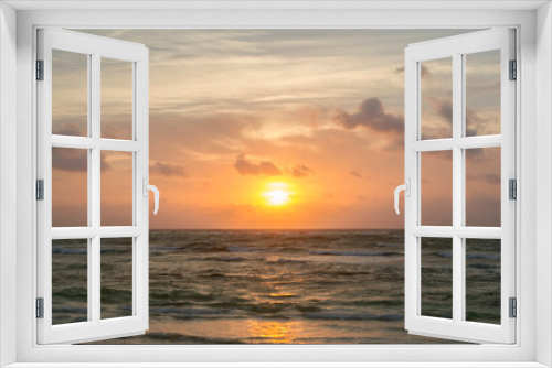 Fototapeta Naklejka Na Ścianę Okno 3D - Heavens. Dramatic beach seascape. Beautiful sunset sky with orange sun rays and clouds, over the sea and ocean waves. The reflection of the sun in the pure water. 