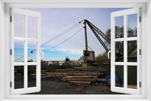 Fototapeta Naklejka Na Ścianę Okno 3D - Rusty old crane in a wood yard in Somerset
