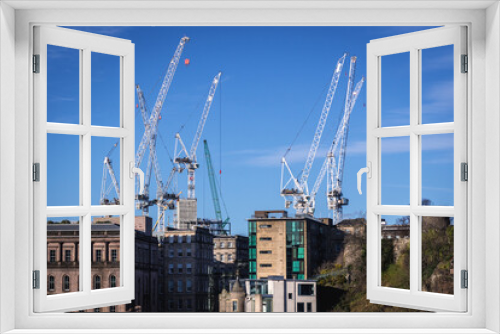 Cranes on construction site, view from Old Town of Edinburgh city, Scotland, UK