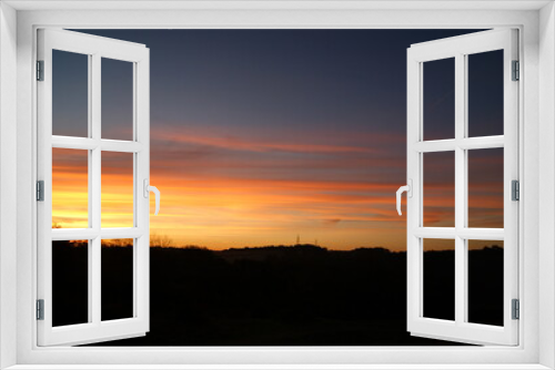 Fototapeta Naklejka Na Ścianę Okno 3D - Beautiful sunrise through a blue sky