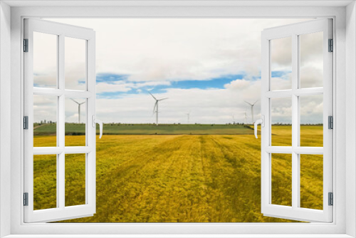 Fototapeta Naklejka Na Ścianę Okno 3D - Wind turbines in field on cloudy day