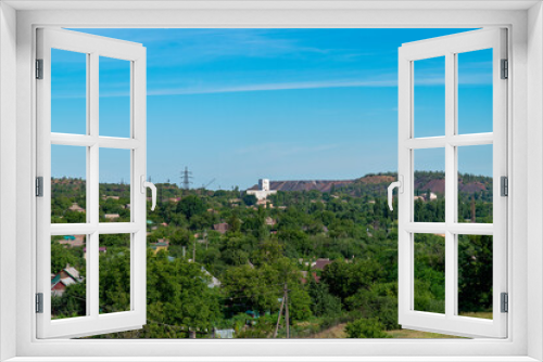 Fototapeta Naklejka Na Ścianę Okno 3D - Ukraine, Krivoy Rog, the 16 of July 2020. View on the city from the old mining dump. Country cottage area down below. 