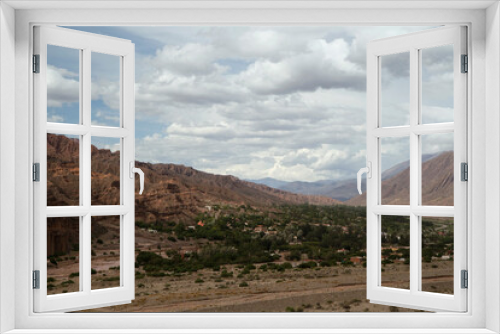 Fototapeta Naklejka Na Ścianę Okno 3D - Idyllic landscape. The valley and desert under a cloudy sky. Panorama view of of the village Tilcara in the Andes mountain range. 