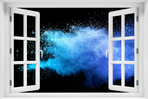 Fototapeta Naklejka Na Ścianę Okno 3D - Closeup of blue dust particle splash isolated on black background.