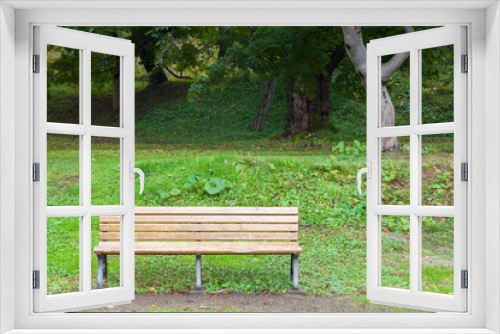 Fototapeta Naklejka Na Ścianę Okno 3D - Wooden bench in green park.