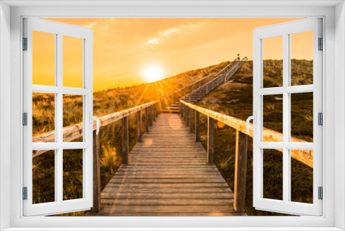 Fototapeta Naklejka Na Ścianę Okno 3D - Sylt island wooden stairs at sunrise. Golden hour landscape