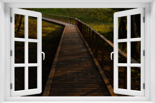 Fototapeta Naklejka Na Ścianę Okno 3D - Wooden footbridge in the lake