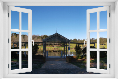 Fototapeta Naklejka Na Ścianę Okno 3D - Beautiful morning view of a beautiful structure along the pond in a park with deep blue sky and tall trees, Fagan park, Galston, Sydney, New South Wales, Australia