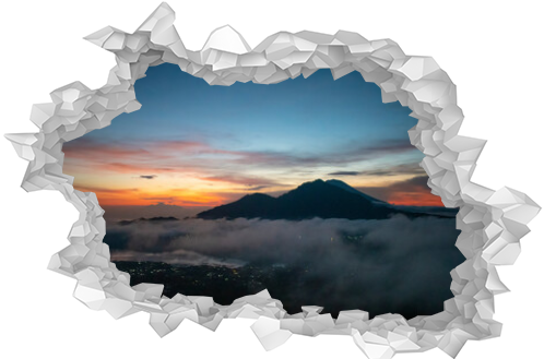 A tranquil landscape view of cloud movement during the morning sunrise with golden sunbeam behind the mountain in Bali