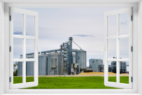 Fototapeta Naklejka Na Ścianę Okno 3D - Modern granary elevator. Metal silos for grain storage, drying, cleaning agricultural products, flour, cereals and grain. Agro-processing concept