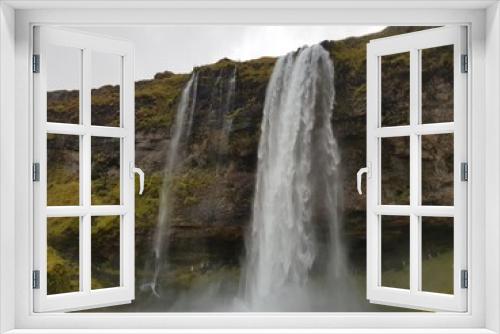 Fototapeta Naklejka Na Ścianę Okno 3D - Waterfall in Iceland. Seljalandsfoss waterfall in Iceland in cloudy weather. Picture was taken on 13th of October 2019.