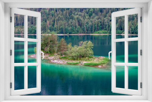 Fototapeta Naklejka Na Ścianę Okno 3D - Small islands with pine-trees in the middle of Eibsee lake with Zugspitze mountain. Beautiful landscape scenery with paradise beach and clear blue water in German Alps, Bavaria, Germany, Europe.