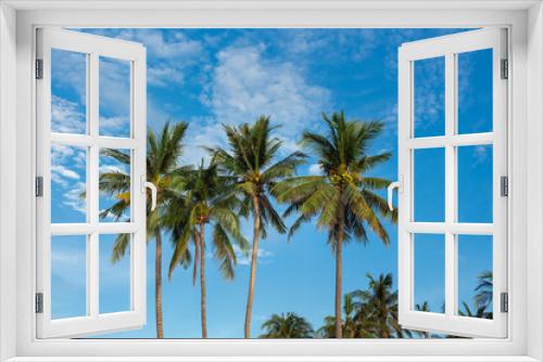 Fototapeta Naklejka Na Ścianę Okno 3D - Three palm trees on blue sky background. Koh Pangan island, Thailand.