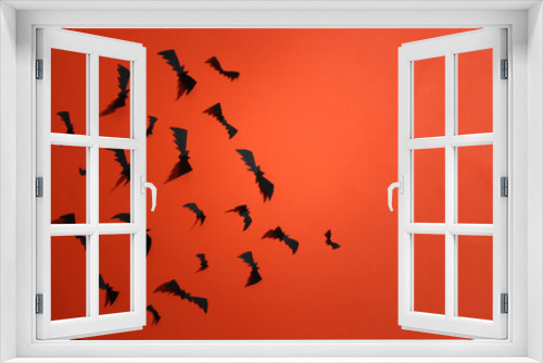 Fototapeta Naklejka Na Ścianę Okno 3D - Paper cut Flying bats and on orange bright background. Halloween background. Top view.  Copy space