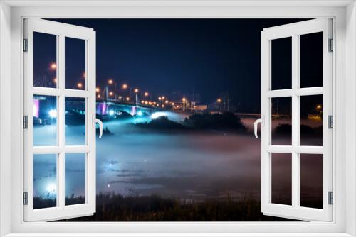 Fototapeta Naklejka Na Ścianę Okno 3D - The beautiful dense foggy nightscape with bridge and lanterns light in the night.