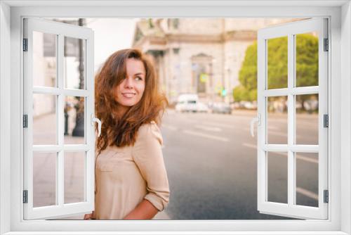 A happy Young woman walks through the historic streets of Saint Petersburg in the center of the city in summer