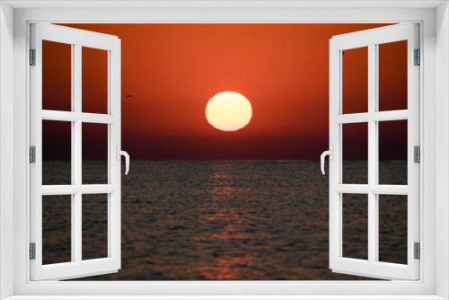 Fototapeta Naklejka Na Ścianę Okno 3D - Beautiful sunrise at sea. The sun rises from the sea. The calm sea