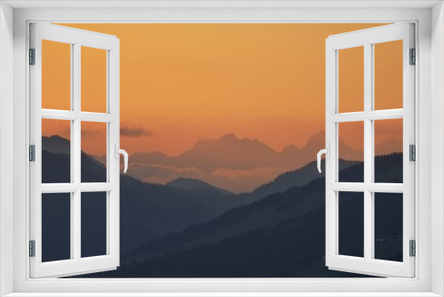 Fototapeta Naklejka Na Ścianę Okno 3D - beautiful sunset on the mountains with orange sky and view to the alps