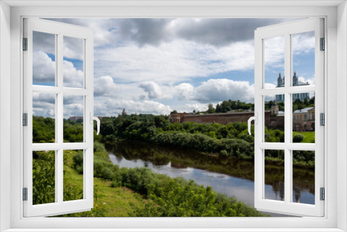 Fototapeta Naklejka Na Ścianę Okno 3D - city view with old buildings and green trees and a river