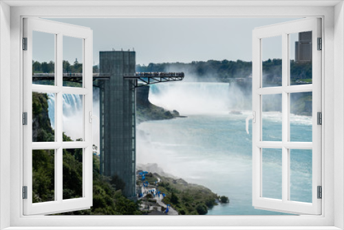 Fototapeta Naklejka Na Ścianę Okno 3D - Niagara falls captured on the border bridge linked America and Canada. The Niagara Falls observation tower is on the left. 