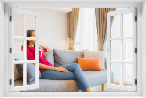 Portrait beautiful young asian woman relax smile on sofa in living area