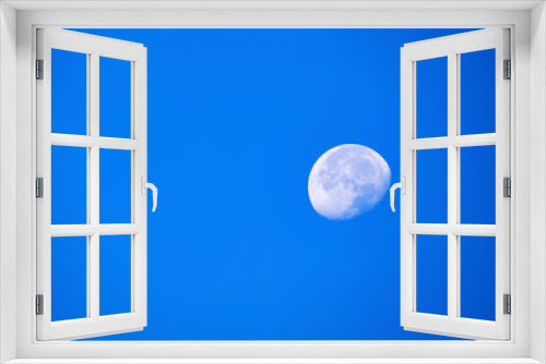 Fototapeta Naklejka Na Ścianę Okno 3D - Waning Moon with Blue Sky
