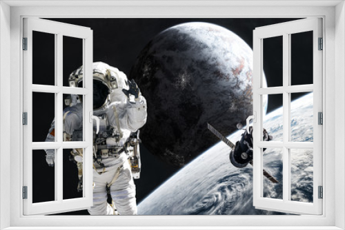 Fototapeta Naklejka Na Ścianę Okno 3D - Astronaut and orbital station in stratosphere of deep space planet. Science fiction. Elements of this image furnished by NASA