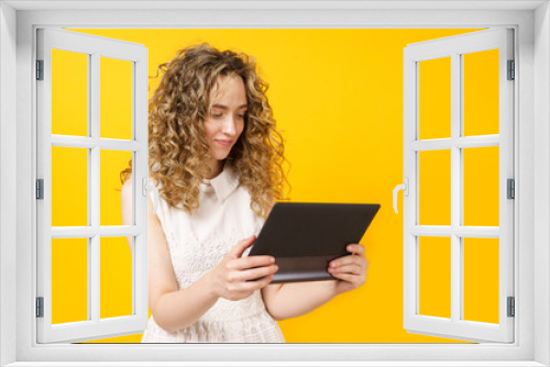 Portrait of a young woman who communicates on a tablet. Female portrait.