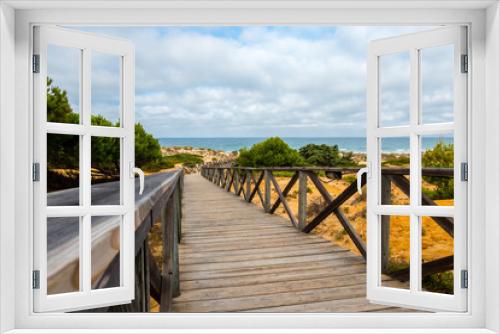 Fototapeta Naklejka Na Ścianę Okno 3D - Wooden walkway that gives access to La Barrosa beach in Sancti Petri, Cadiz