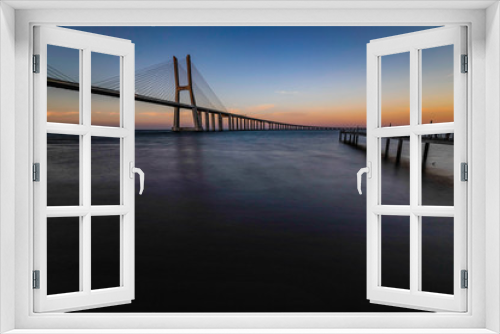Fototapeta Naklejka Na Ścianę Okno 3D - The Vasco da Gama Bridge is a cable-stayed bridge flanked by viaducts and spans the Tagus River in Parque das Nações in Lisbon, the capital of Portugal. It is the longest bridge in the European Union