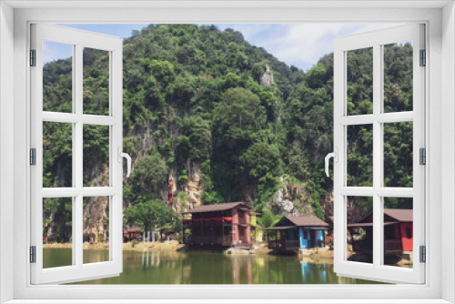 Fototapeta Naklejka Na Ścianę Okno 3D - Beautiful landmark that surrounded by mountains and green facing clearly reflective lake in Ipoh, Malaysia.
