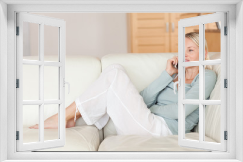 Woman sitting on the couch talking on the phone