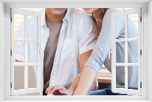 Smiling couple with notebook in the kitchen