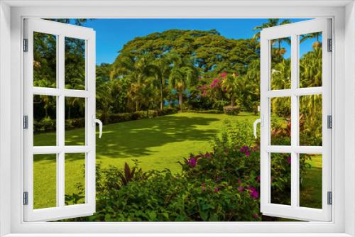 Fototapeta Naklejka Na Ścianę Okno 3D - A view across a well kept garden in St Kitts