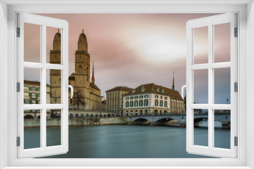 Fototapeta Naklejka Na Ścianę Okno 3D - Grossmünster Cathedral in Zürich, Switzerland. Long Exposure of the Grossmünster Cathedral and old town from Limmat river.