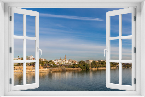 Fototapeta Naklejka Na Ścianę Okno 3D - Guadalquivir river and a part of the city of Seville Spain on a wonderful sunny day and a blue sky with few white clouds