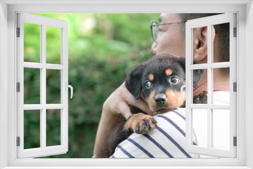 Fototapeta Naklejka Na Ścianę Okno 3D - Adult man holding little puppy dog on his shoulder