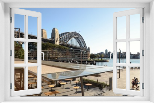Fototapeta Naklejka Na Ścianę Okno 3D - Campbells Cove, showing Sydney Harbour, Harbour Bridge, empty restaurant and joggers looking over to Milsons Point.