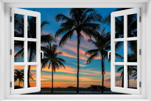 Fototapeta Naklejka Na Ścianę Okno 3D - South beach with palm trees silhouette at spectacular pink sunrise in Miami Beach, Florida. 