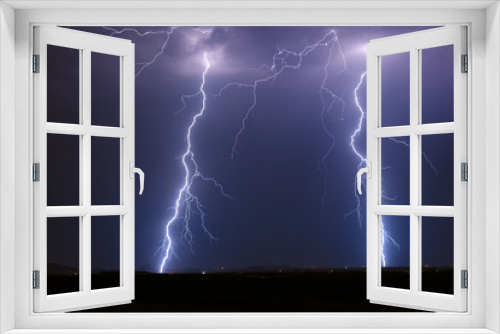 Fototapeta Naklejka Na Ścianę Okno 3D - Twin lightning bolt strikes in a thunderstorm