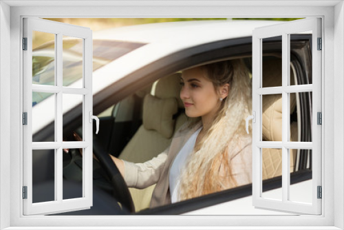 beautiful young woman driving a car