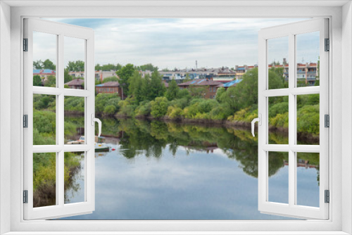 Fototapeta Naklejka Na Ścianę Okno 3D - Summer russian river townscape of green embankment
