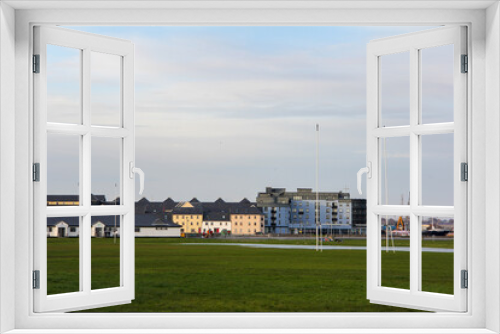 Fototapeta Naklejka Na Ścianę Okno 3D - Rugby field in the middle of a meadow and with buildings in the background in Galway, Ireland