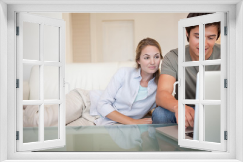 Relaxed couple using a laptop