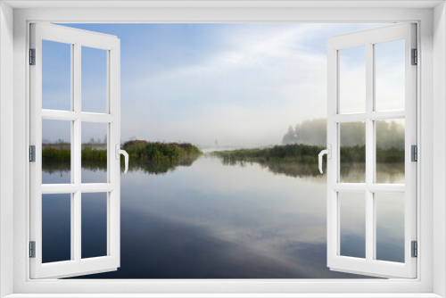 Fototapeta Naklejka Na Ścianę Okno 3D - Beautiful morning sunrise over blue forest lake with reeds and reflection of clouds