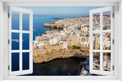 Fototapeta Naklejka Na Ścianę Okno 3D - Aerial view of Polignano a Mare, a village built on the edge of the sandstone cliffs above the Adriatic Sea south of Bari in the Apulia region of Italy (southeast)