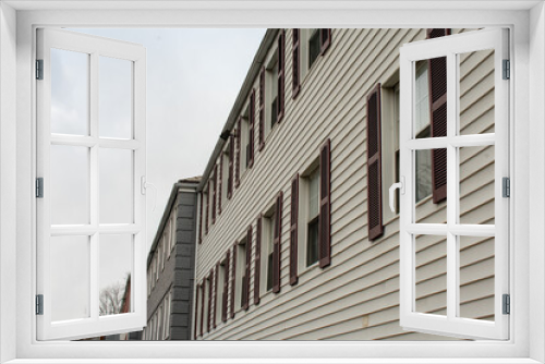 Fototapeta Naklejka Na Ścianę Okno 3D - Repeating Windows With Brown Shutters on a White Apartment Building