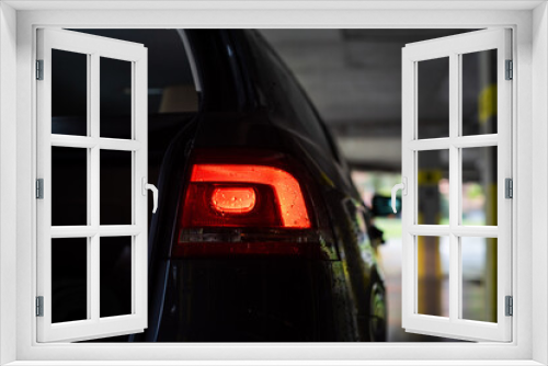 Fototapeta Naklejka Na Ścianę Okno 3D - The bright taillights of a modern car glow
