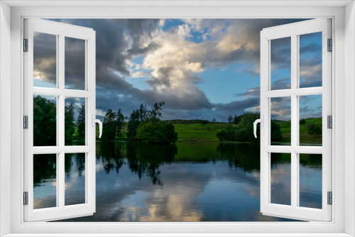 Fototapeta Naklejka Na Ścianę Okno 3D - Beautiful cloudy sky has reflection in forest lake during sunset